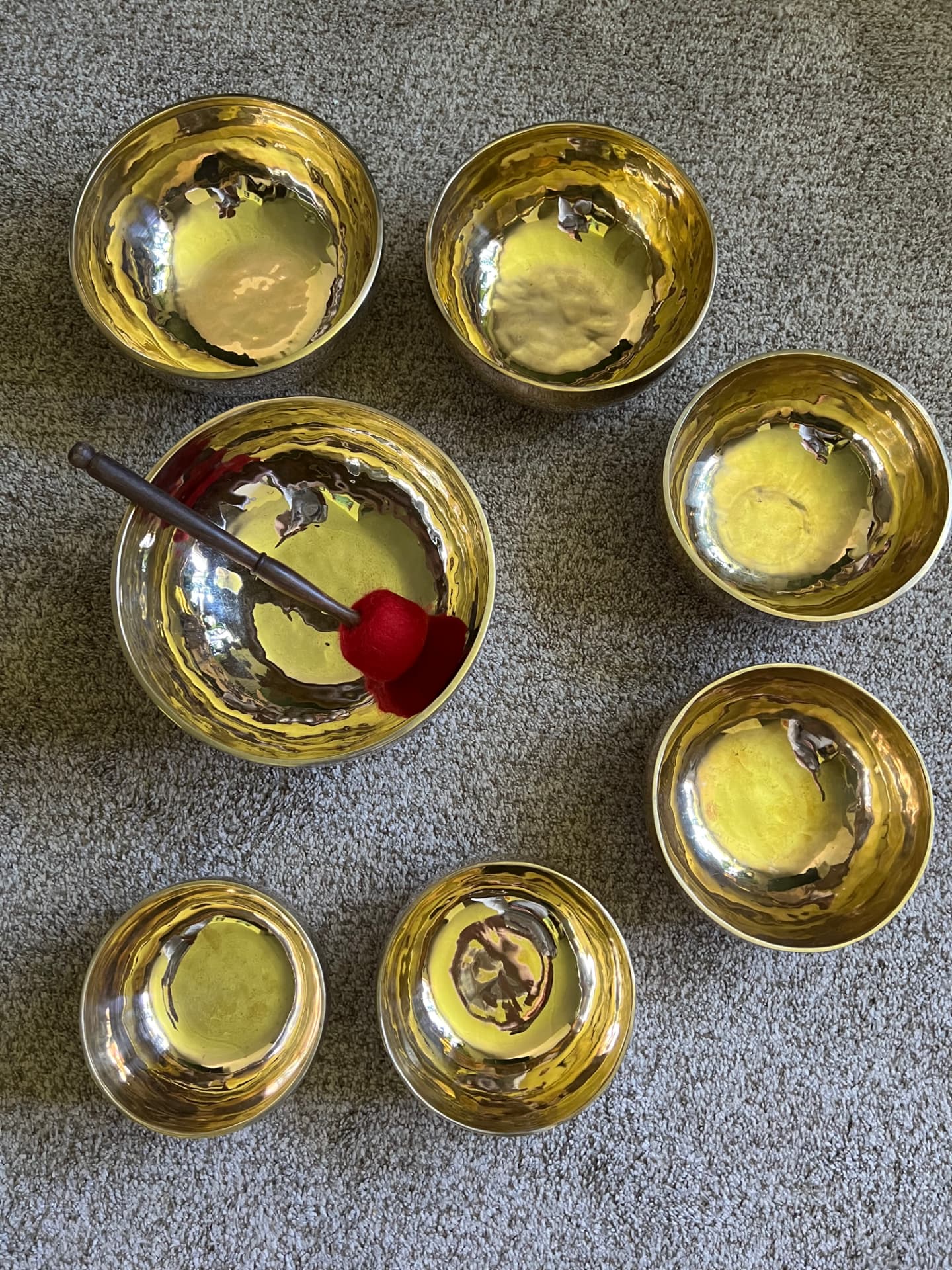 Emily Curry's handmade Tibetan sound bowls laid out with a mallet